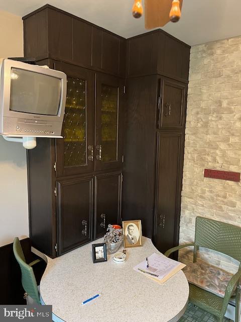 dining room with brick wall