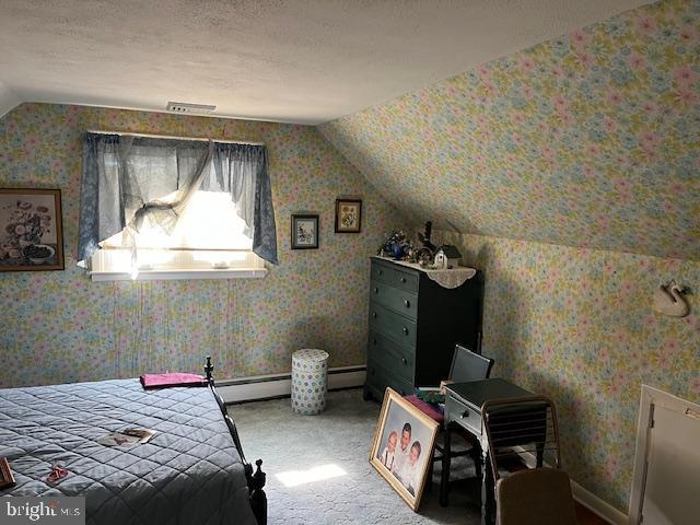 carpeted bedroom featuring vaulted ceiling and wallpapered walls