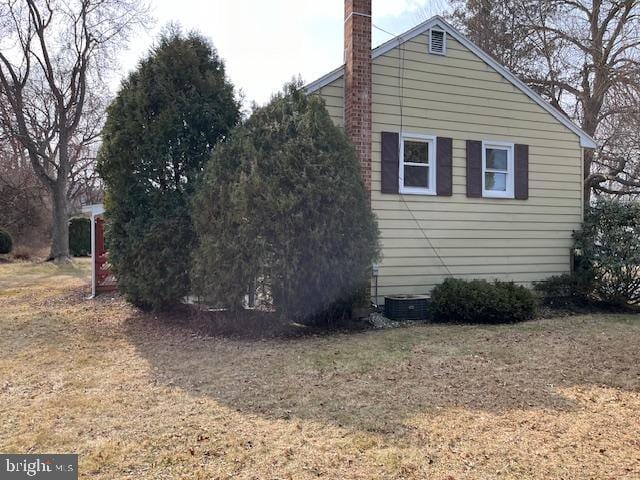 view of property exterior featuring a chimney