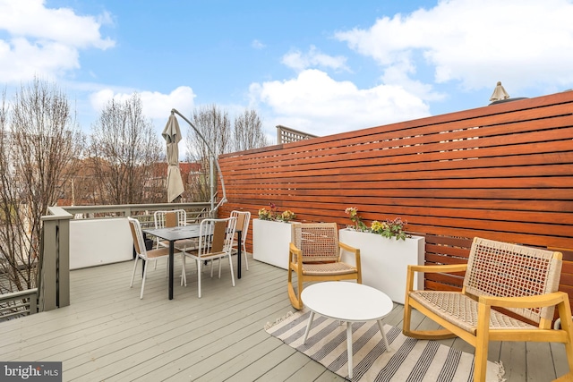 wooden deck featuring outdoor dining area