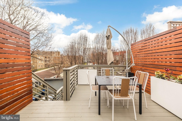 wooden terrace with outdoor dining space