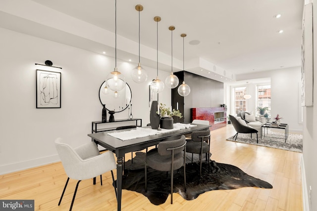 dining area with recessed lighting, wood finished floors, and baseboards