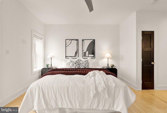 bedroom featuring ceiling fan, baseboards, and wood finished floors