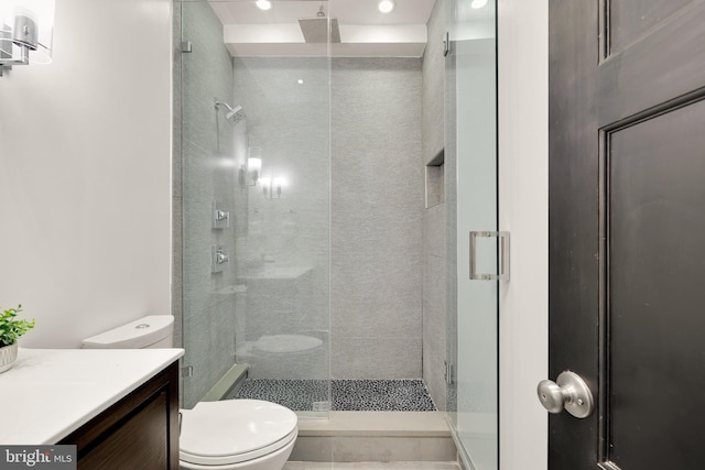 full bath featuring vanity, a shower stall, and toilet