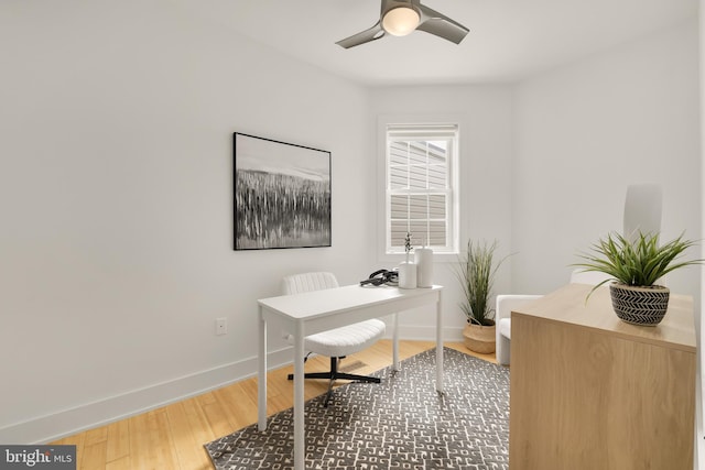 office space featuring wood finished floors, a ceiling fan, and baseboards