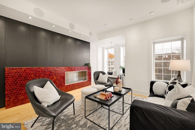 living area with light wood finished floors, plenty of natural light, and recessed lighting