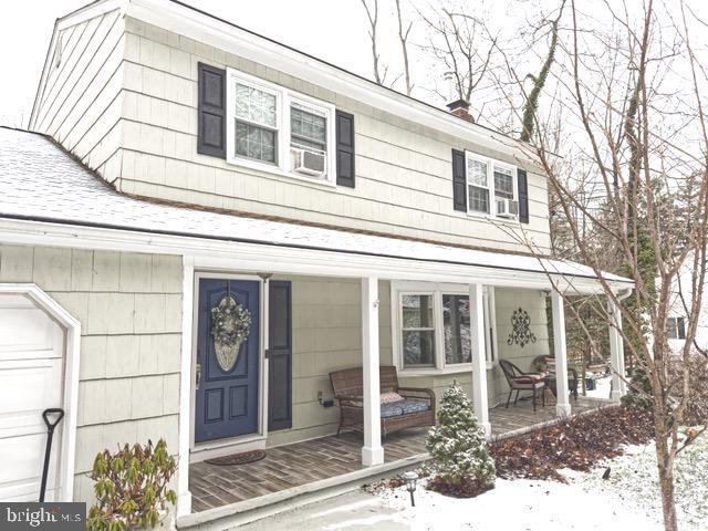 view of front of property featuring a porch and a chimney