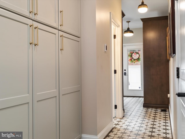 hall with light floors and baseboards