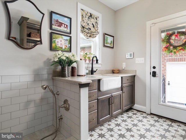 bathroom with vanity, baseboards, and tile patterned floors