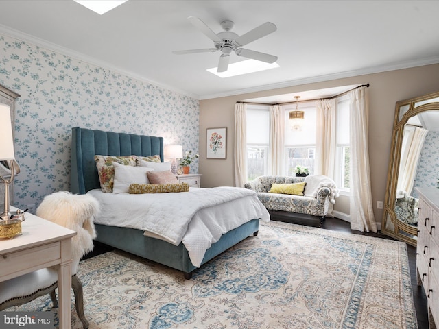 bedroom with ornamental molding, wood finished floors, a ceiling fan, and wallpapered walls