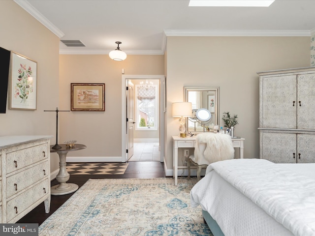 bedroom featuring ornamental molding, wood finished floors, visible vents, and baseboards