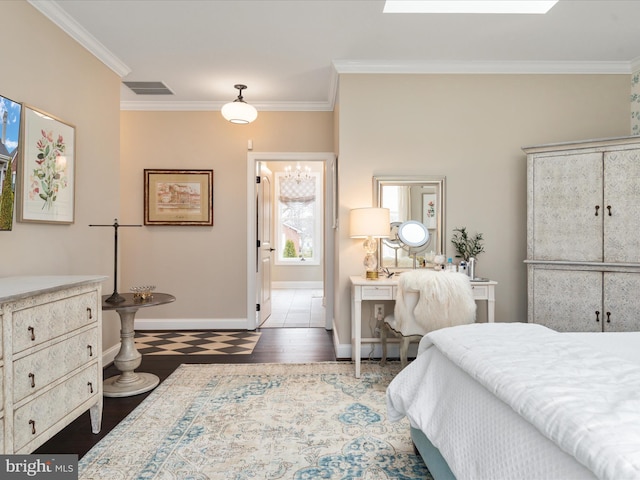 bedroom featuring ornamental molding, wood finished floors, visible vents, and baseboards