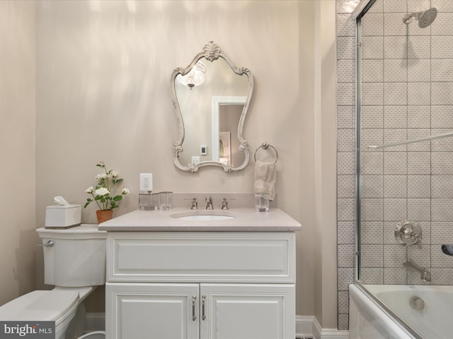 bathroom featuring bathtub / shower combination, vanity, and toilet