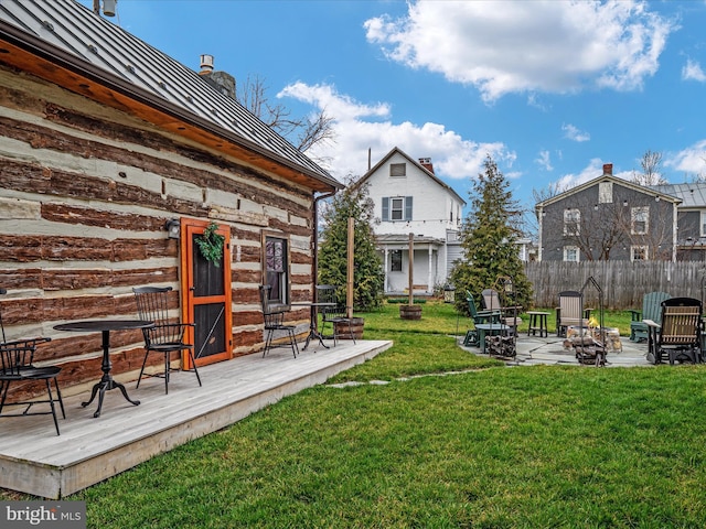 view of yard with an outdoor fire pit and fence