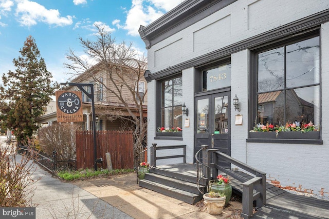 doorway to property with brick siding