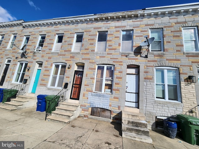 view of property featuring stone siding