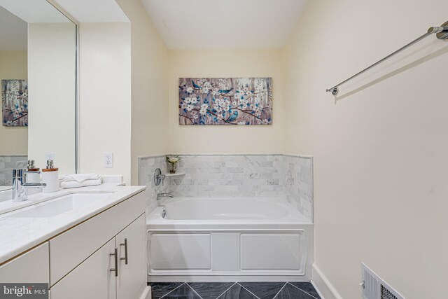 full bathroom with marble finish floor, visible vents, a garden tub, and vanity