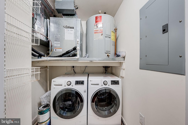 laundry area featuring laundry area, electric panel, electric water heater, and separate washer and dryer