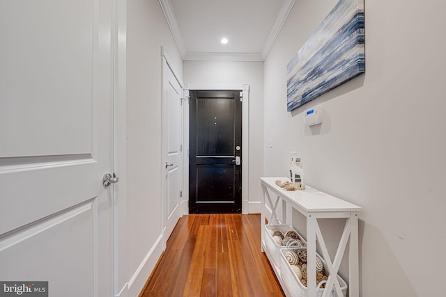 doorway featuring ornamental molding, recessed lighting, and wood finished floors