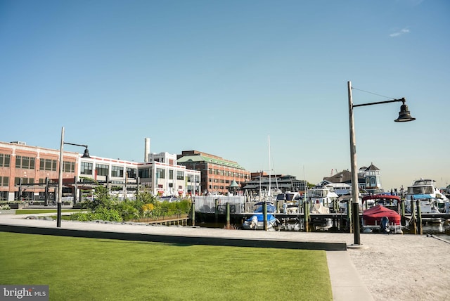 view of property's community featuring a boat dock and a lawn