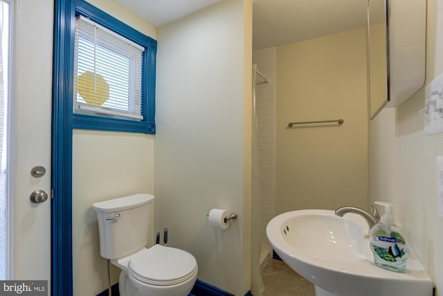 full bathroom with tile patterned flooring, baseboards, a sink, and toilet