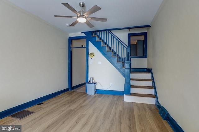 interior space with visible vents, crown molding, baseboards, and wood finished floors