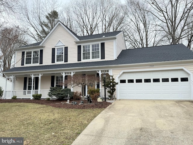 view of front facade with roof with shingles, covered porch, a garage, driveway, and a front lawn