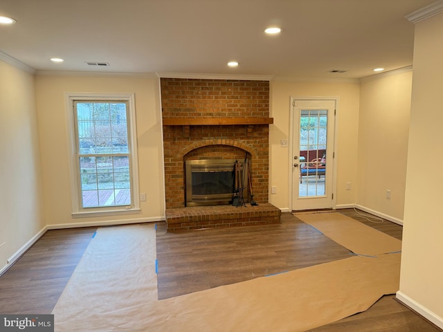 unfurnished living room with crown molding, visible vents, wood finished floors, and recessed lighting