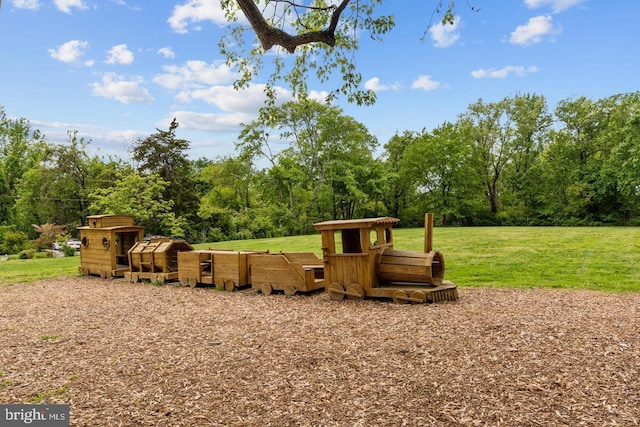 view of playground featuring a lawn, an outdoor structure, and exterior structure