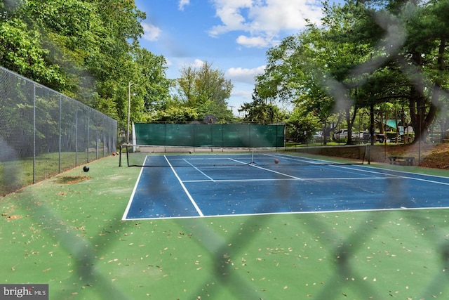 view of tennis court with fence