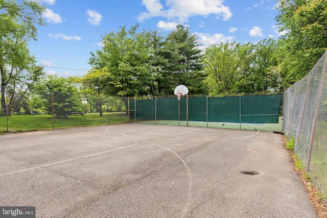 view of basketball court featuring community basketball court and fence