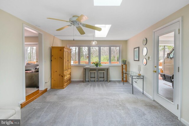 interior space with a skylight, baseboards, and a wealth of natural light