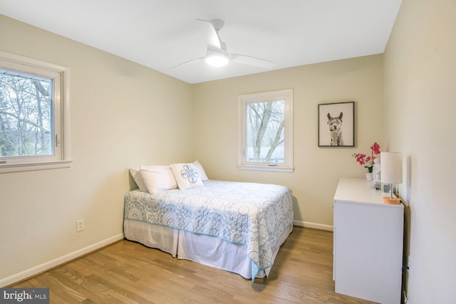 bedroom with wood finished floors, a ceiling fan, and baseboards