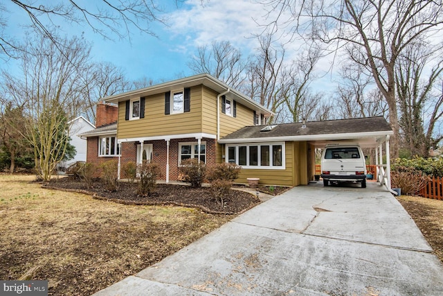 view of front of property with driveway, brick siding, and an attached carport