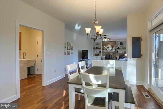 dining area with baseboards, a fireplace, visible vents, and dark wood finished floors