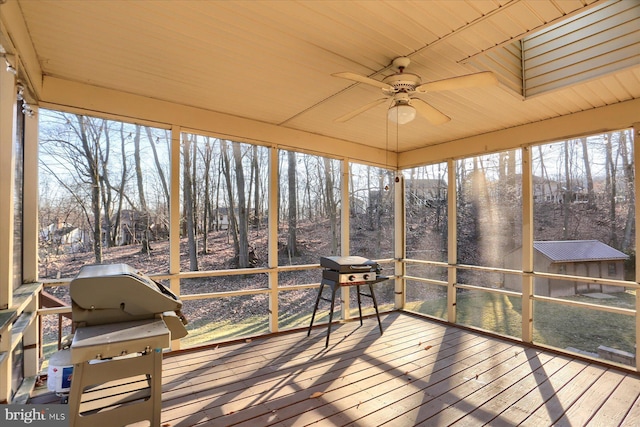 sunroom / solarium with wood ceiling and ceiling fan