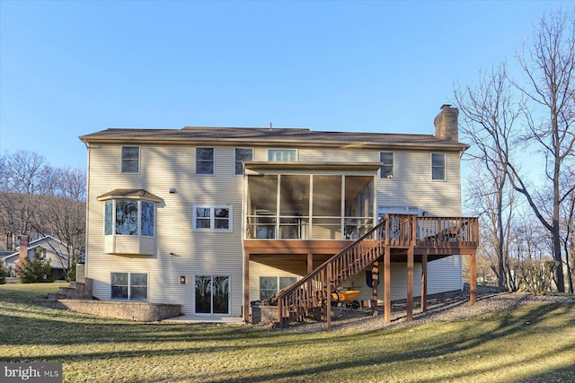 back of house with a deck, a sunroom, a yard, stairway, and a chimney