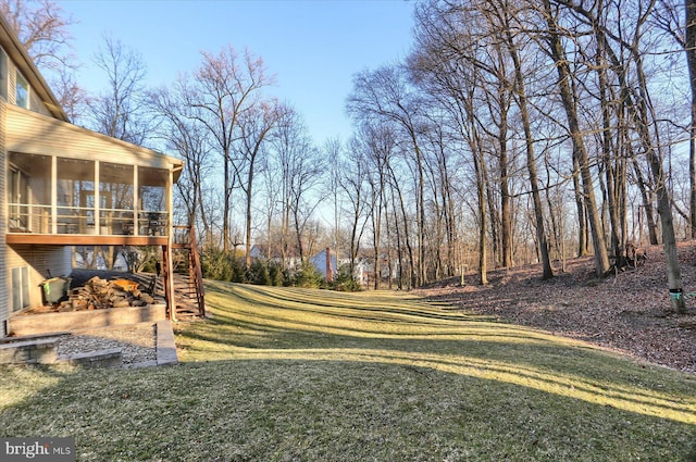 view of yard featuring stairs and a sunroom