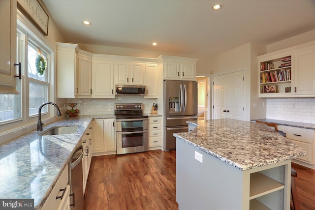 kitchen with dark wood-style floors, open shelves, a sink, and stainless steel appliances