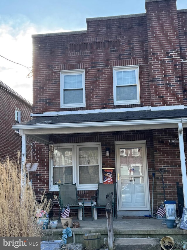 view of front of property featuring a porch and brick siding