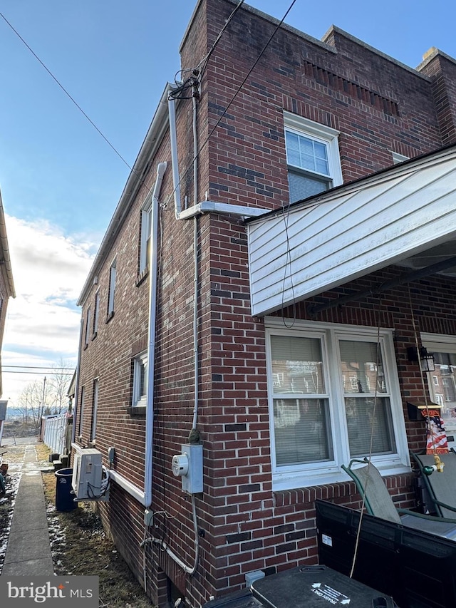 view of side of property with brick siding