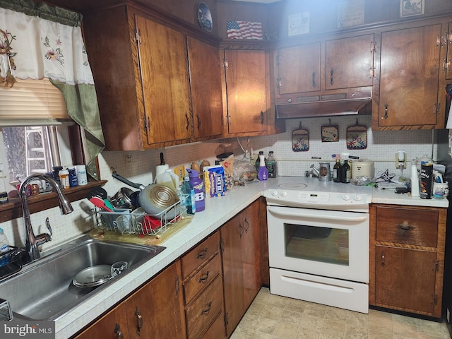 kitchen with light countertops, a sink, white range with electric stovetop, and under cabinet range hood