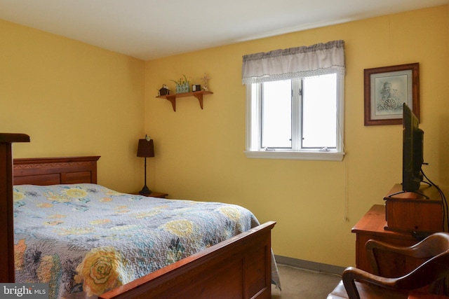 bedroom featuring baseboards and carpet flooring