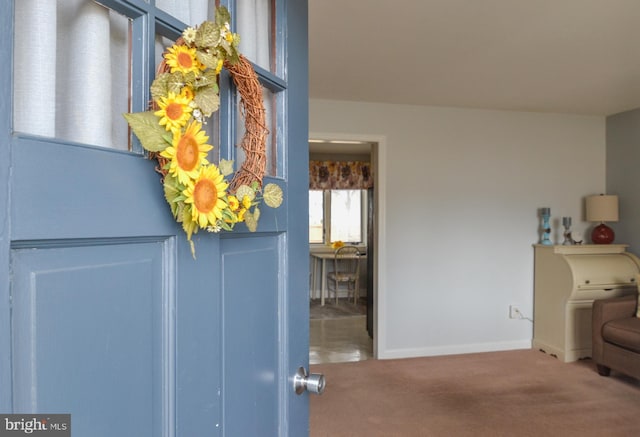 interior space featuring carpet floors and baseboards