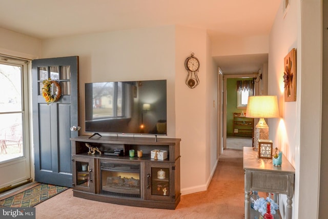 living room with carpet, visible vents, and baseboards