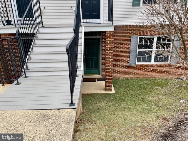 doorway to property featuring brick siding