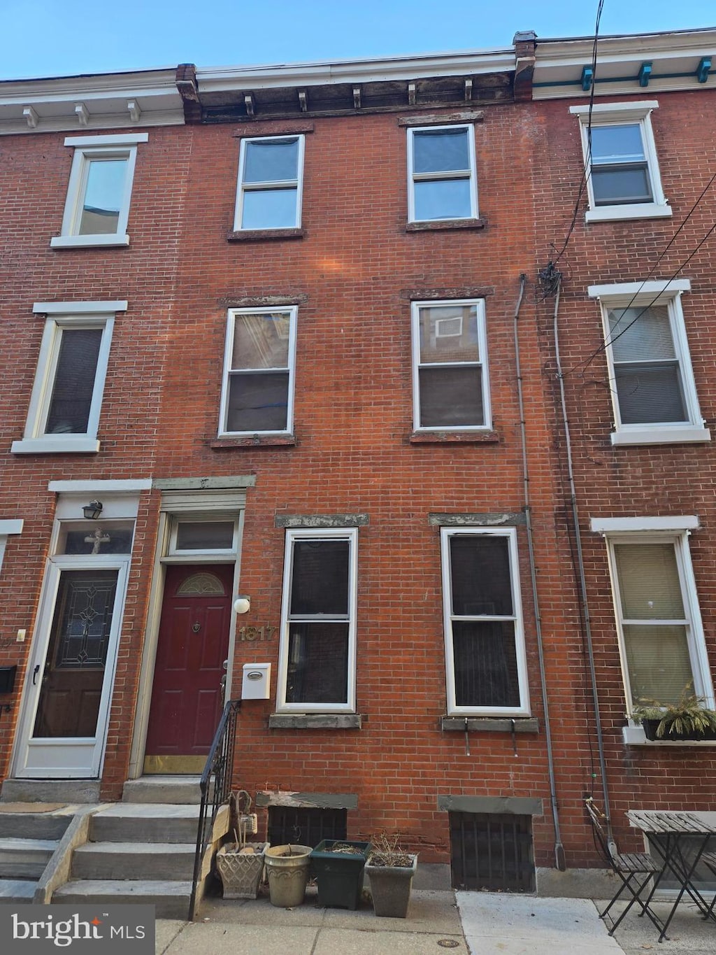 view of front of home featuring entry steps and brick siding