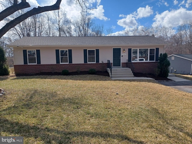 ranch-style home with brick siding and a front yard