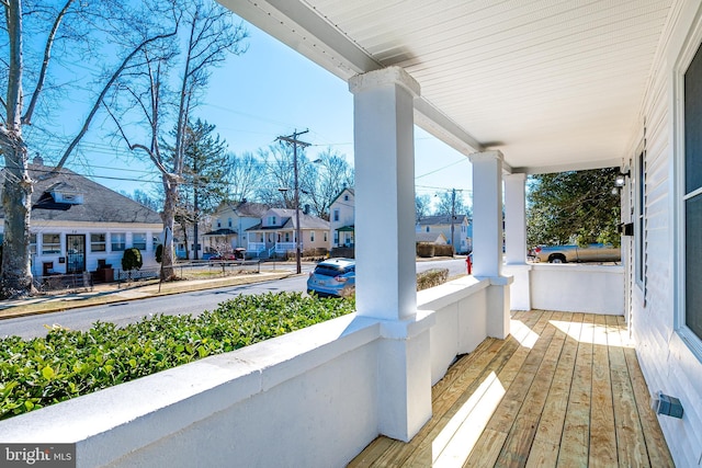 balcony featuring covered porch and a residential view