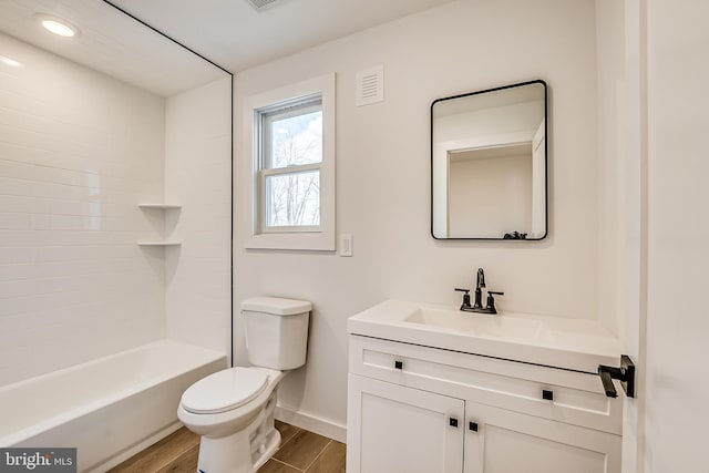 full bathroom featuring visible vents, toilet, vanity, wood finished floors, and baseboards